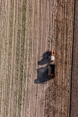 Fototapeta premium aerial view of harvest fields with tractor