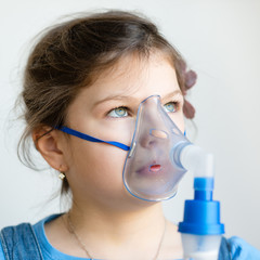 girl with asthma / allergy inhaler - inhalation mask