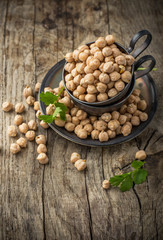 Vintage silver cup filled with dry chickpeas on