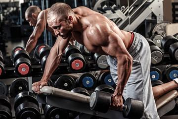 Fototapeta na wymiar Man working out in gym