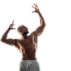 Young muscular guy on white background