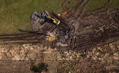 aerial view of long arm excavator working on the field
