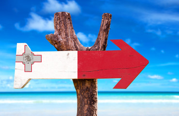 Malta Flag wooden sign with beach background