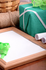 Fototapeta na wymiar green gift box and wooden board, holiday concept