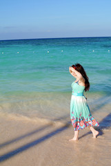 Girl is walking along the seashore