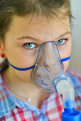 girl with asthma / allergy inhaler - inhalation mask