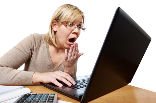 Frightened woman with glasses looking at laptop isolated