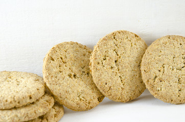Integral cookies and wheat on white background