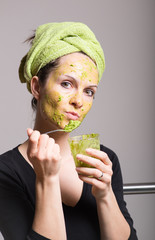 Young woman with an avocado facial mask