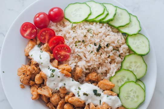 Gyros chicken with rice, tzatziki dressing and vegetables