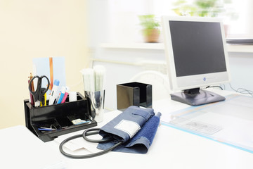 Doctor office table with office tools, monitor, tonometer