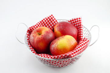 Apples with red napkin in a white basket