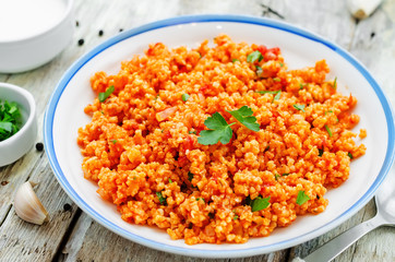 millet porridge with tomato sauce, garlic and parsley