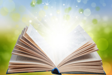 Open magic book with light effects