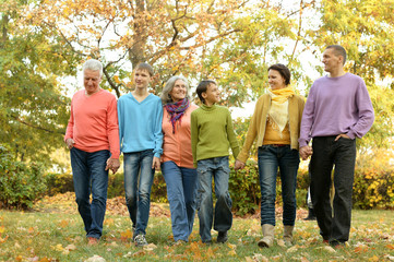 Family relaxing in autumn park