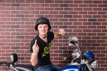 Fototapeta na wymiar Man on Motorcycle Giving Finger and Swearing