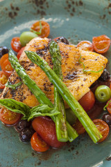 organic Arctic char (sea trout) on a bed of roasted tomatoes top