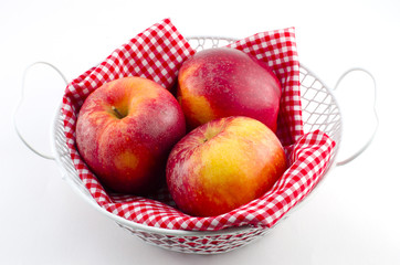Apples with red napkin in a white basket