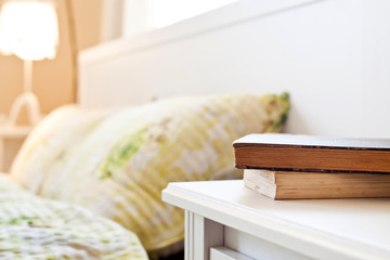 Fototapeta na wymiar bedroom with books on nightstand