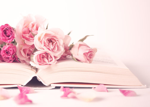 Fototapeta Vintage pink peonies on top of a book over beige background