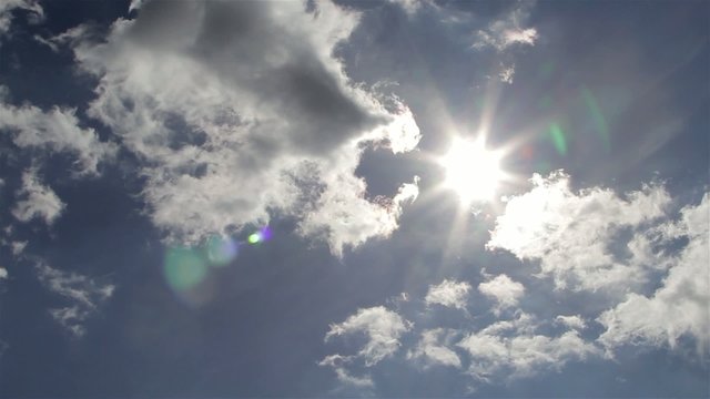 Heavenly Clouds Reveal Beautiful Sun Light Lens Flare in Blue Sky