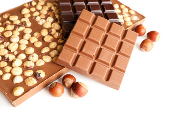 Black and milk chocolate bars with hazelnuts isolated on white