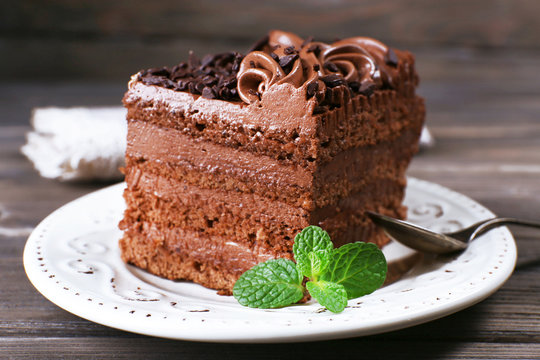 Tasty piece of chocolate cake with mint