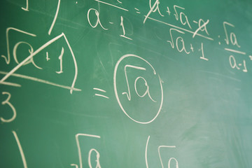 Mathematics formulas on blackboard background