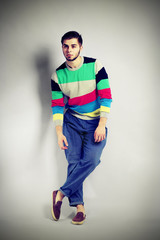 Young man in casual style on gray background