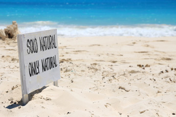 Sign announcing the beginning of the naturist zone on the beach - 81525664