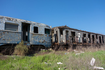 Fototapeta na wymiar Old abandoned trains in sunny day