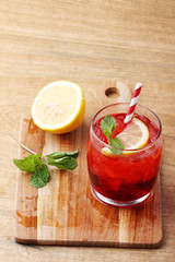 cold red soft drink from raspberry syrup and mint