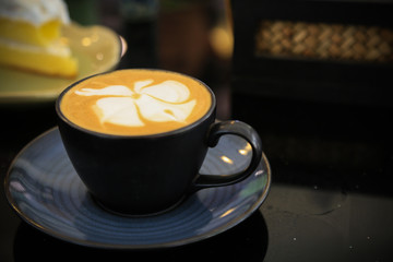 Fresh coffee on wooden table. Espresso coffee short on table.