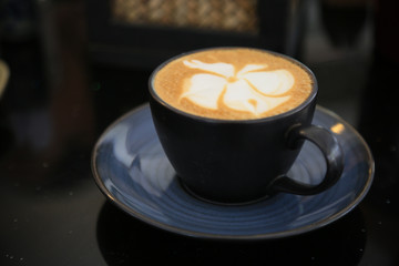 Fresh coffee on wooden table. Espresso coffee short on table.