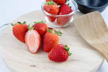 red strawberry on wood block