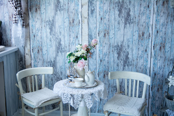 The interior in blue tones with two chairs and a vase with flowe