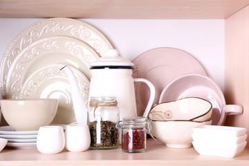 Fototapeta na wymiar Kitchen utensils and tableware on shelf