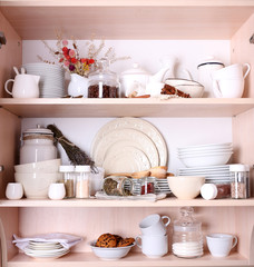 Kitchen utensils and tableware on shelves