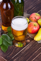 Apple and pear cider glass and bottles with fruits
