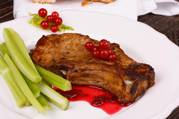 Fried pork chop with red currant sauce and celery