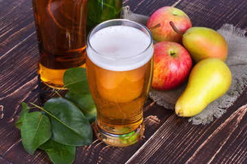 Apple and pear cider glass and bottles with fruits