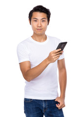 Young asian man texting message at his mobile phone