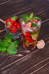 Strawberry mojito cocktail on wooden background
