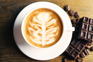 Cup of coffee latte art with grains and chocolate