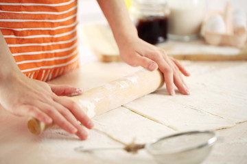 Obraz na płótnie Canvas Making croissant cookies. Rolling dough.
