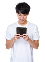 Asian man standing with tablet computer