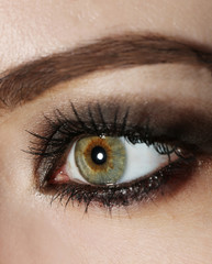 Naklejka premium Eye of young woman with tear drop close up
