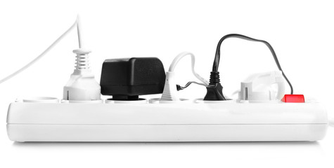Many plugs plugged in extension cord isolated on white