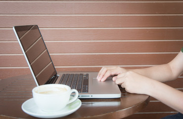 Close up woman hands working with laptop