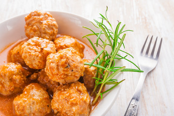 Bowl with meatballs and tomato sauce